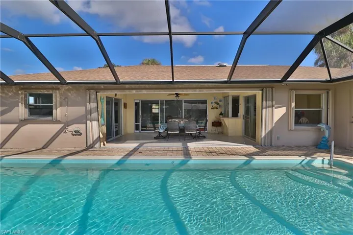 View of swimming pool with a patio and a lanai