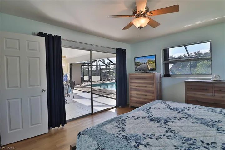 Bedroom featuring ceiling fan, light hardwood / wood-style flooring, and access to outside