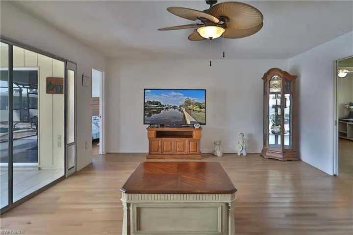 Living room featuring ceiling fan and light hardwood / wood-style floors