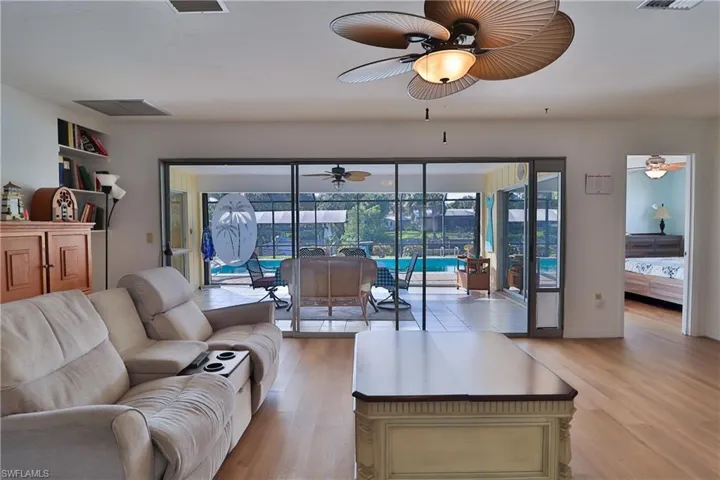 Living room featuring ceiling fan and light wood-type flooring