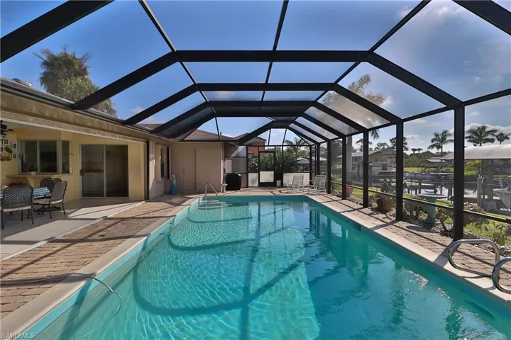 View of swimming pool with a lanai and a patio area