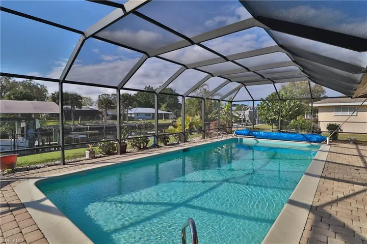 View of swimming pool with glass enclosure