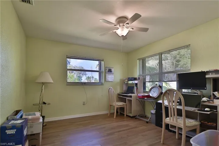 Office featuring hardwood / wood-style floors, a wealth of natural light, and ceiling fan