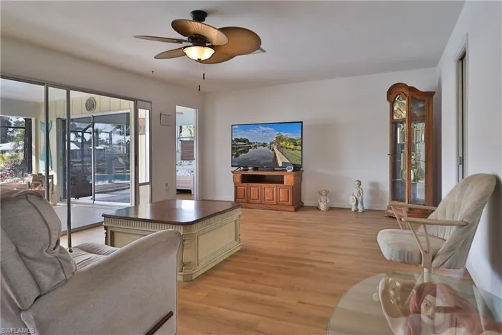 Living room featuring ceiling fan and light wood-type flooring