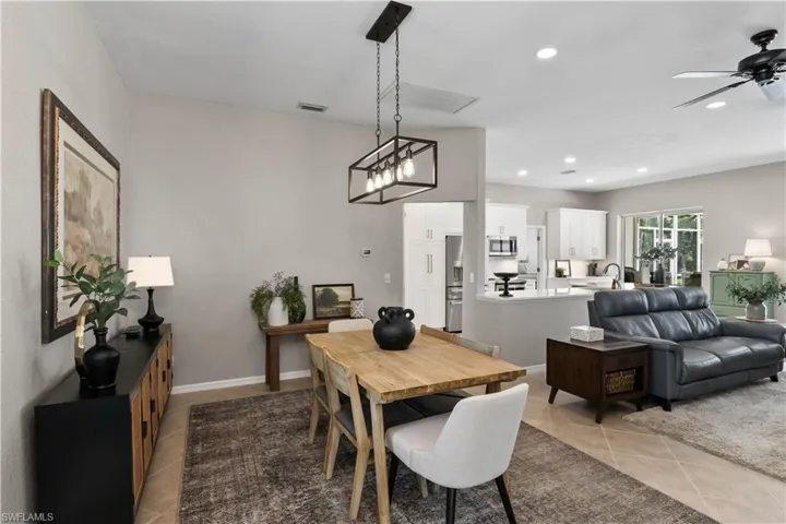 Dining room featuring ceiling fan, sink, and light tile patterned floors