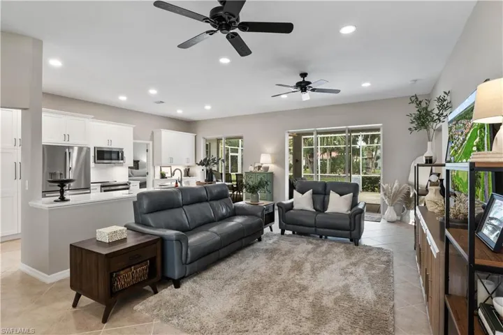 Living room with ceiling fan and light tile patterned floors