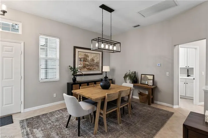 Dining space with light tile patterned floors