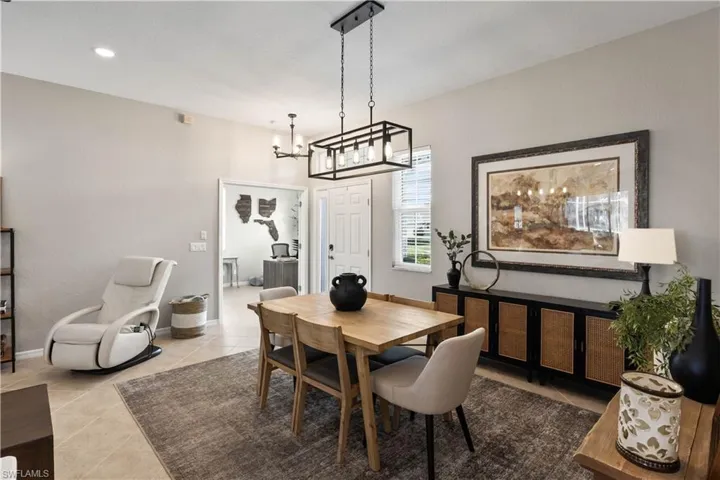 Tiled dining space with a chandelier