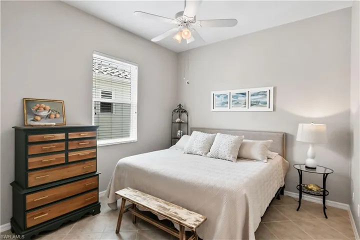 Tiled bedroom with ceiling fan