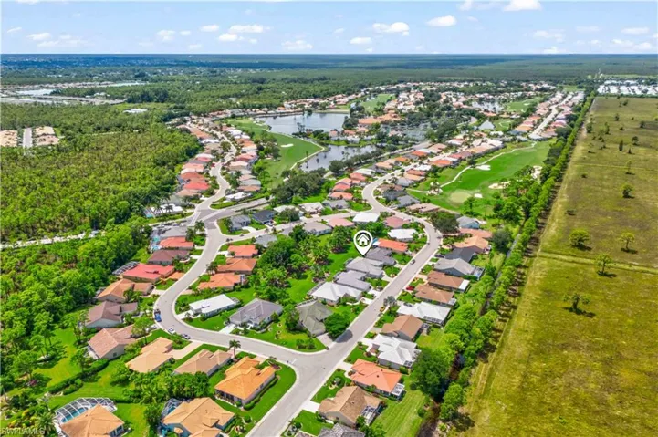 Birds eye view of property with a water view