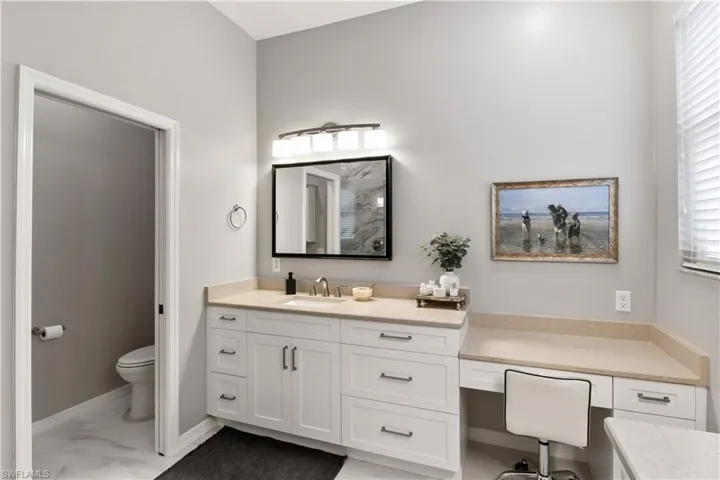 Bathroom with plenty of natural light, toilet, and vanity