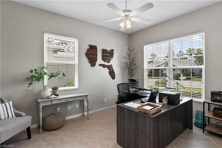 Tiled home office featuring a healthy amount of sunlight and ceiling fan