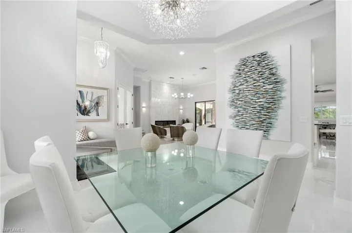 Dining area with a coffered ceiling and a contemporary chandelier
