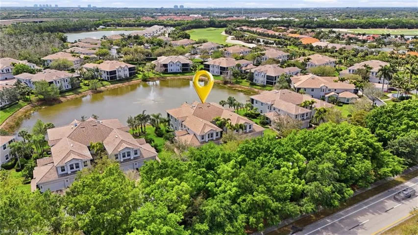 Aerial perspective of suburban area featuring a large body of water