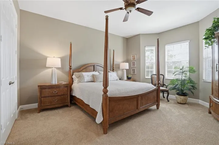 Bedroom with light carpet and ceiling fan