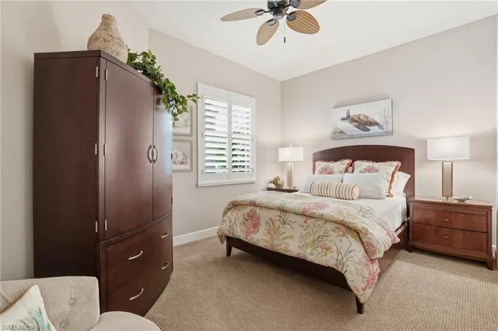 Bedroom featuring light colored carpet and ceiling fan