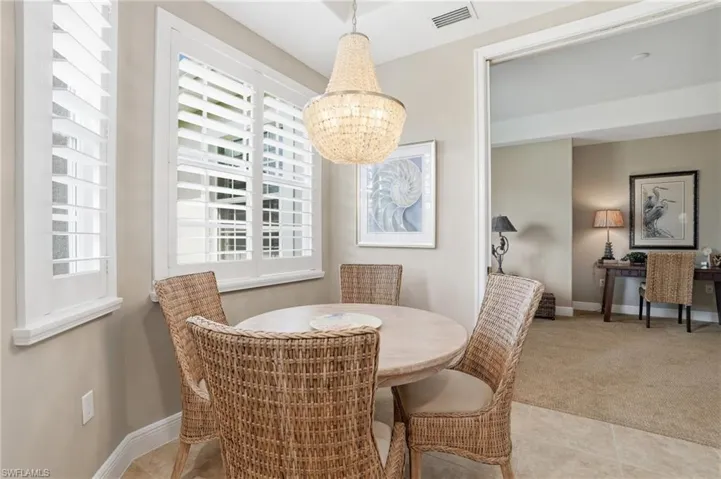 Dining space featuring baseboards and light colored carpet