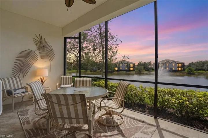 Sunroom featuring a water view