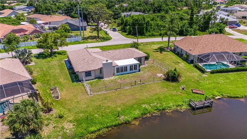 Birds eye view of property with a water view