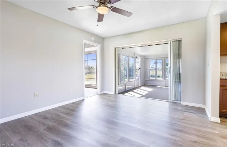 Unfurnished room featuring ceiling fan and hardwood / wood-style flooring