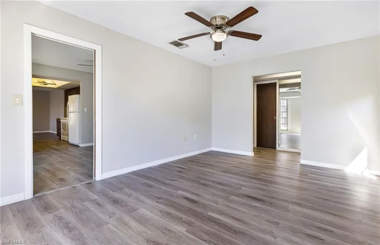 Empty room featuring hardwood / wood-style flooring and ceiling fan