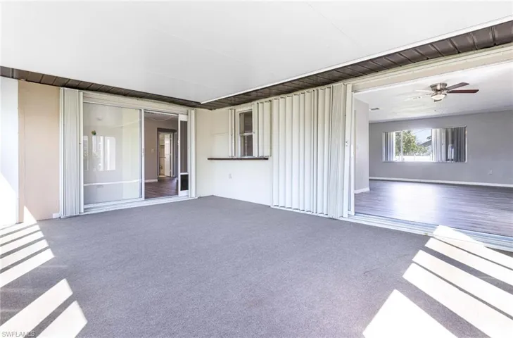 Unfurnished living room featuring wood-type flooring and ceiling fan