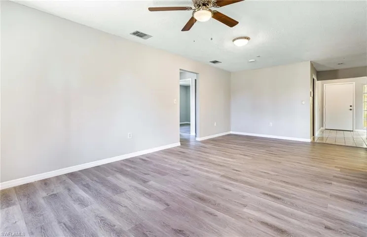 Tiled spare room with ceiling fan and a textured ceiling