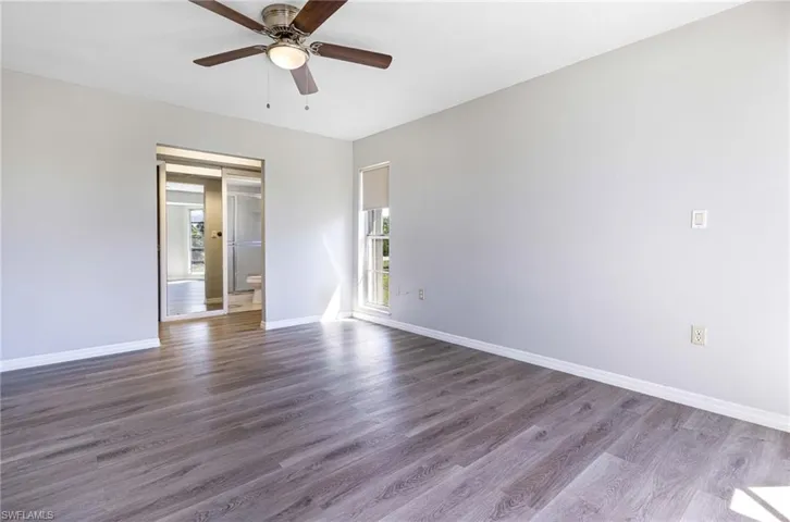 Empty room featuring ceiling fan and hardwood / wood-style floors