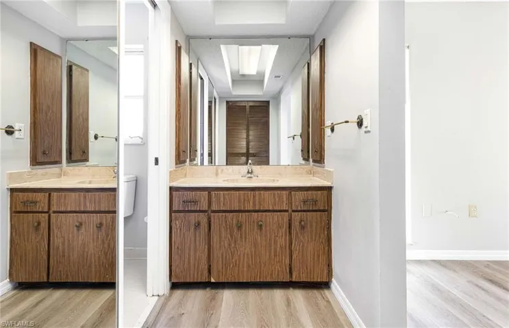 Bathroom featuring hardwood / wood-style floors, toilet, and vanity