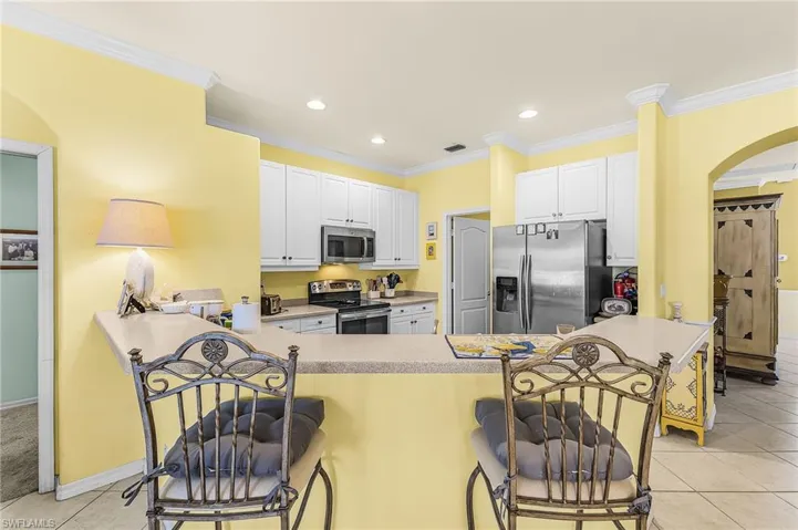 Open kitchen with counter seating.