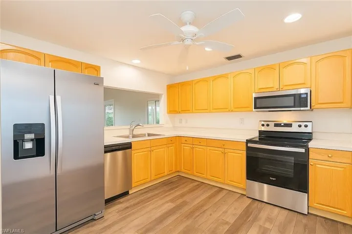 Kitchen featuring appliances with stainless steel finishes, light countertops, and recessed lighting