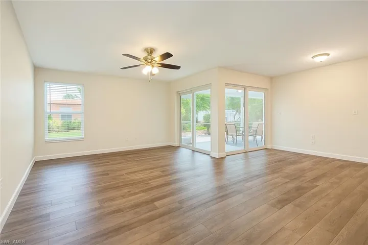 Unfurnished living room featuring LVP floors and ceiling fan
