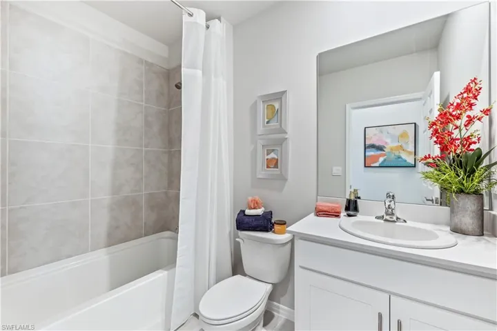 Full bathroom featuring vanity, toilet, and shower / bath combo with shower curtain