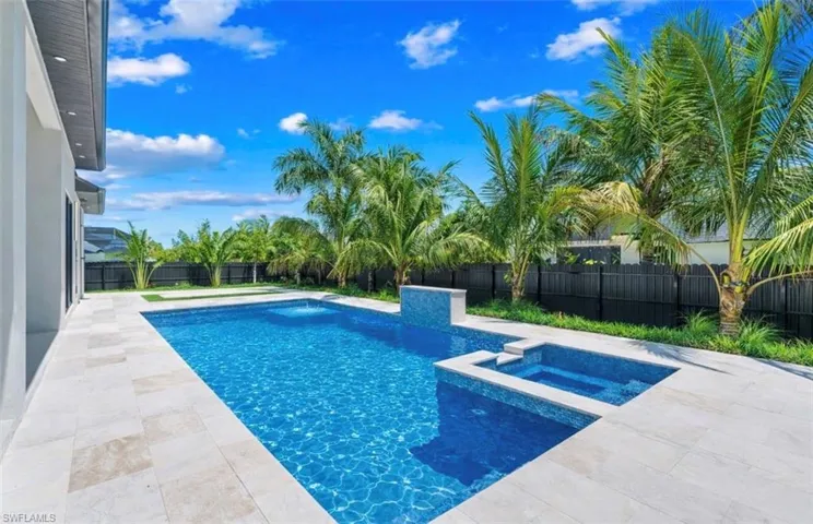 Relaxing pool / spa with a patio area and a fenced backyard