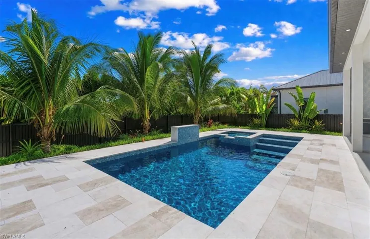 Integrated pool / spa featuring a fenced backyard and a patio area