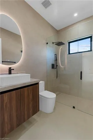 Bathroom featuring a stall shower and vanity