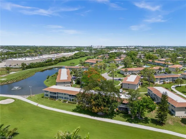 Drone / aerial view of a large body of water and a local golf course