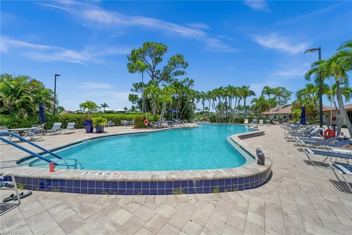 Community pool with a patio