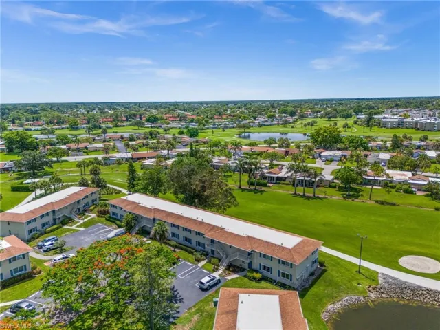 Aerial view of residential area with a large body of water and a golf course