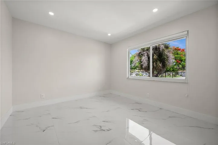 Spare room featuring light marble finish flooring and recessed lighting