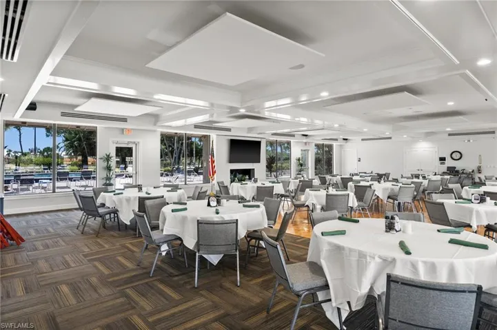 Dining area featuring coffered ceiling, dark colored carpet, and beamed ceiling