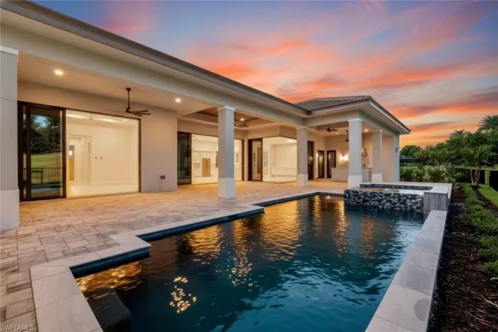 View of pool featuring a patio and a pool with connected hot tub