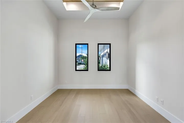 Spare room featuring a ceiling fan and light wood-type flooring