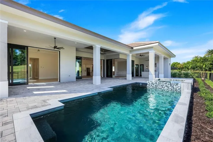 View of pool featuring a patio area and a pool with connected hot tub