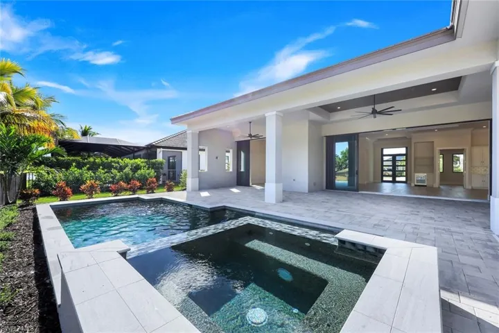 View of swimming pool featuring a patio area and a pool with connected hot tub