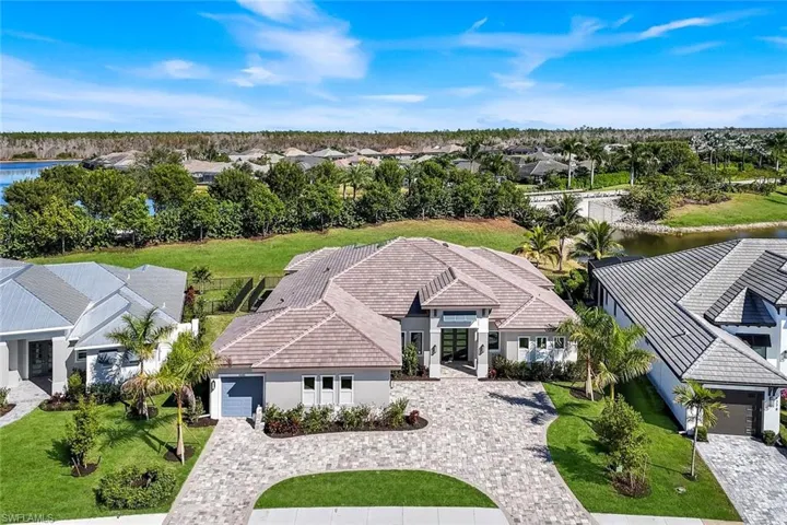 Aerial view of residential area featuring a nearby body of water