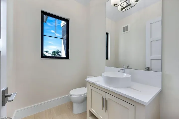 Bathroom with light wood-style floors and vanity