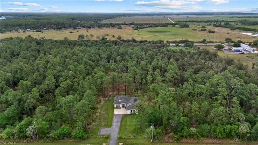 Birds eye view of property featuring a rural view and a forest view