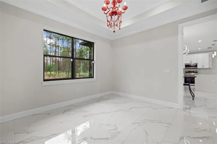 Primary Bedroom featuring a large trey ceiling