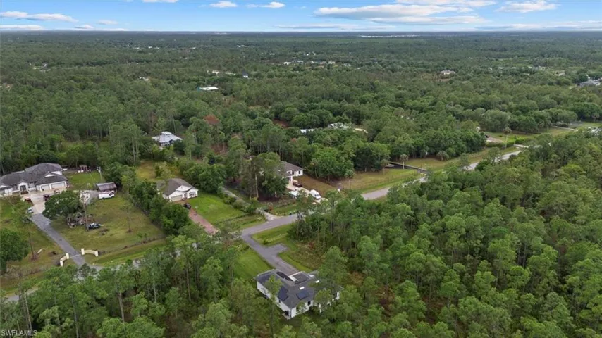 Birds eye view of property with a view of trees
